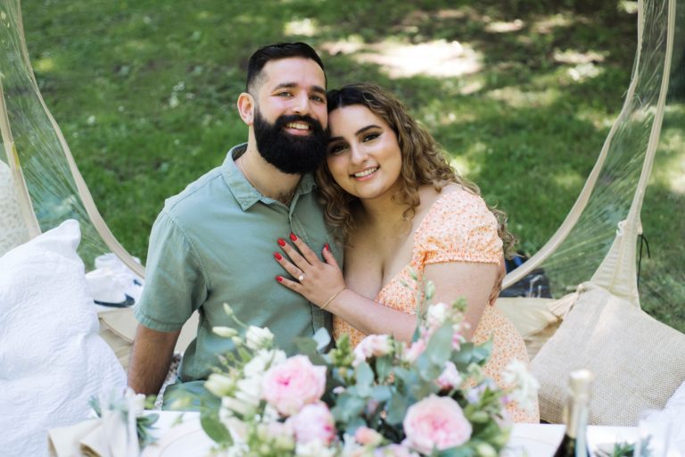 Engagement photo at a pop-up picnic in a park in Portland, Oregon